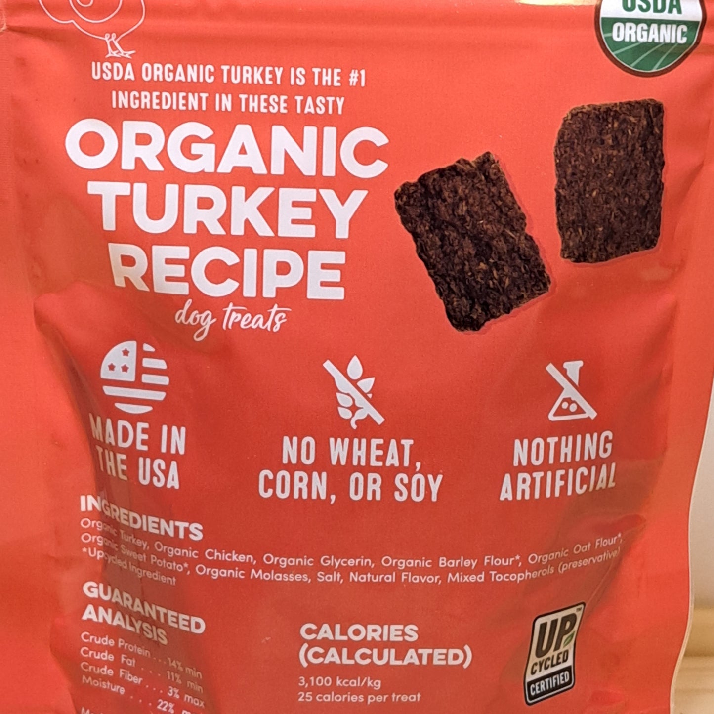 Red package of organic turkey recipe dog treats with visible branding and text.
